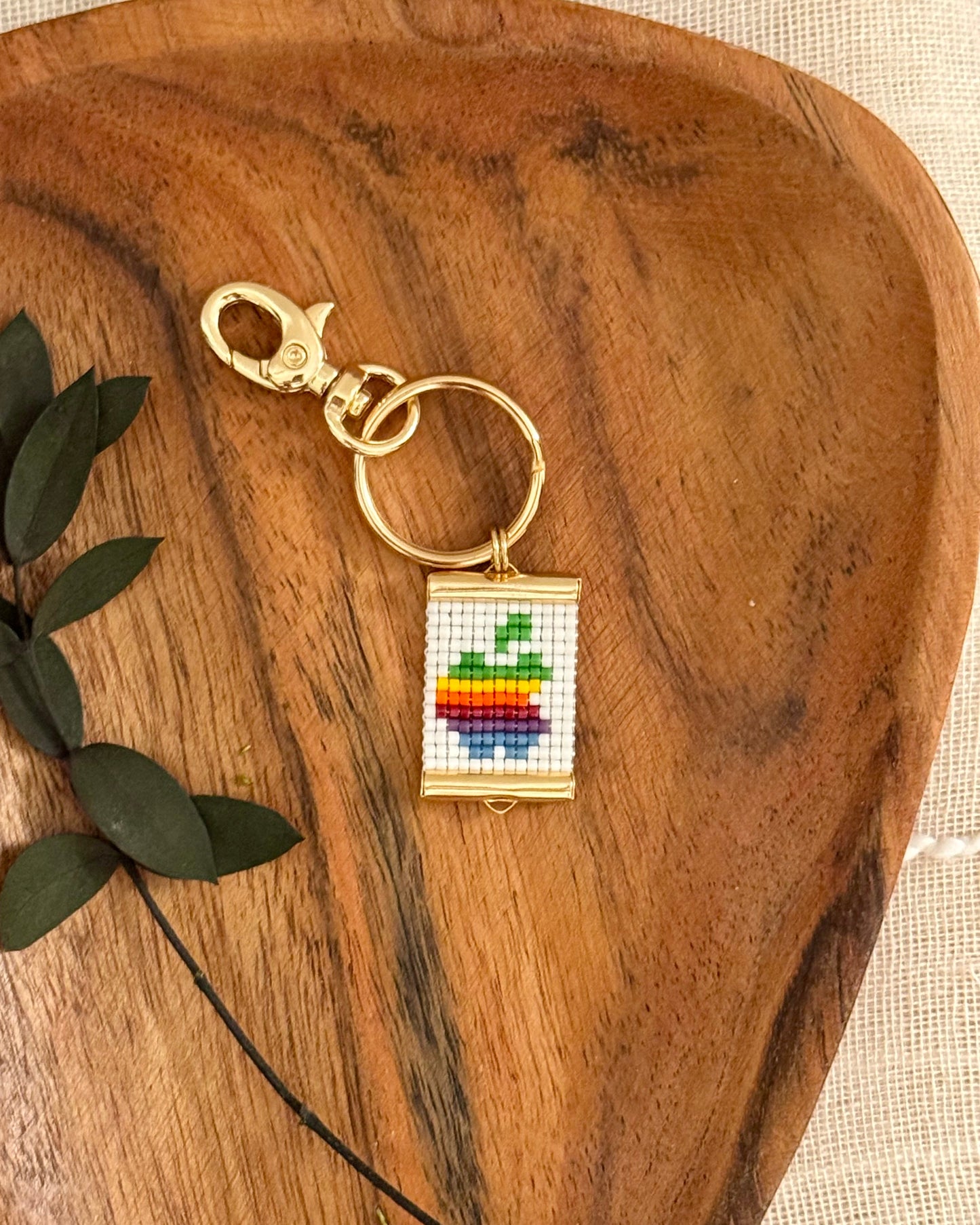 Keychain with rainbow design on a wooden surface