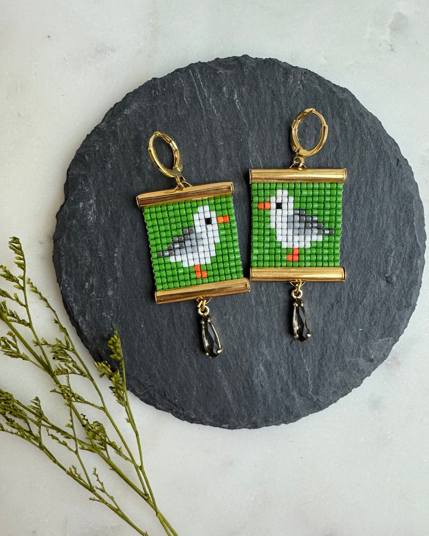 Pair of earrings with bird design on a round slate stone