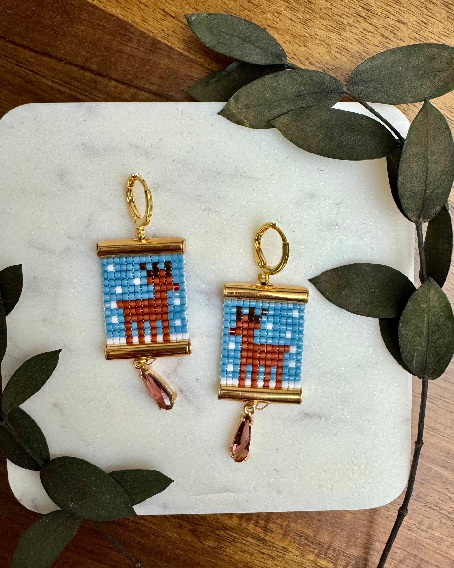 Rudolph Earrings on White Marble Coaster