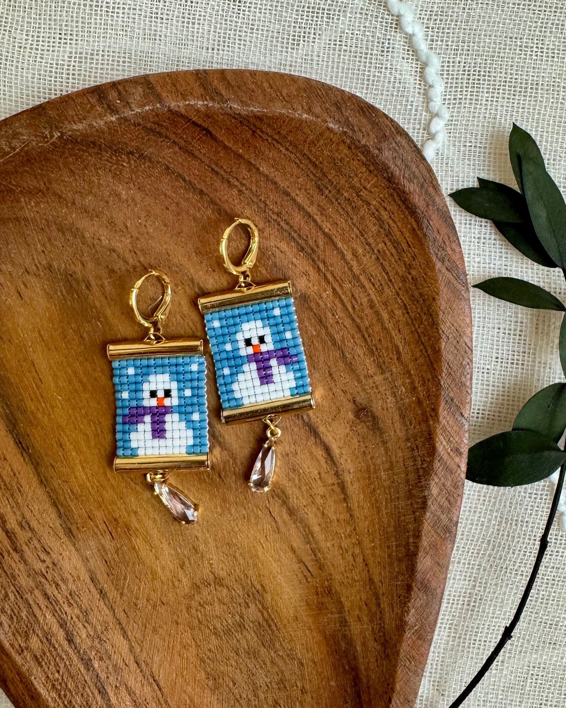 Beaded earrings depicting snowmen.